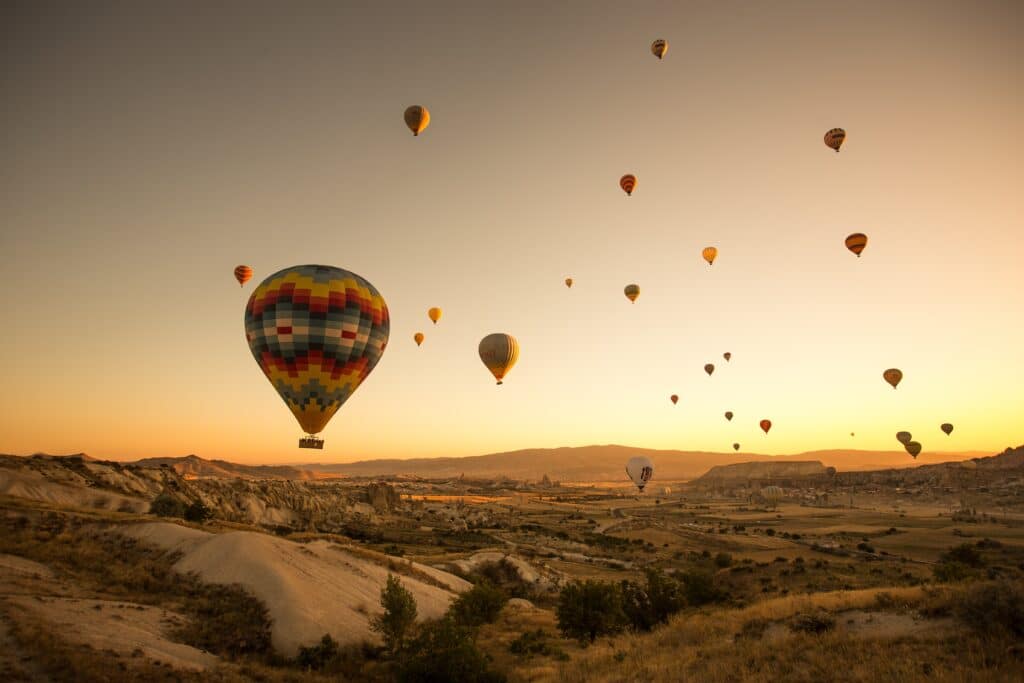 Set Of Colored Balloons Flying Above The Ground In Cappadocia, Turkey